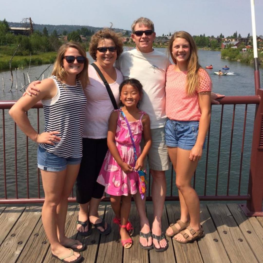 A family sitting with their dog