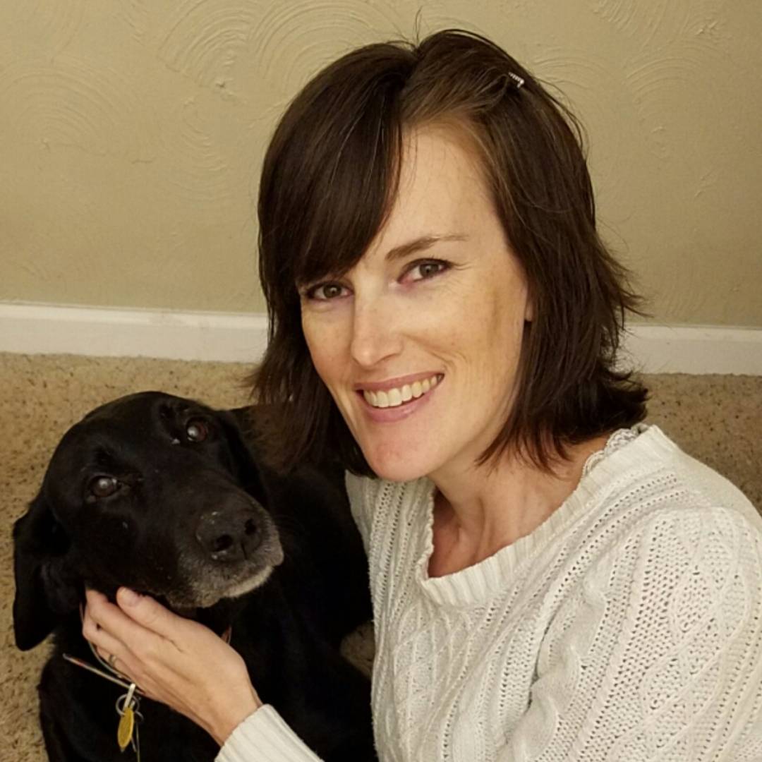A family sitting with their dog