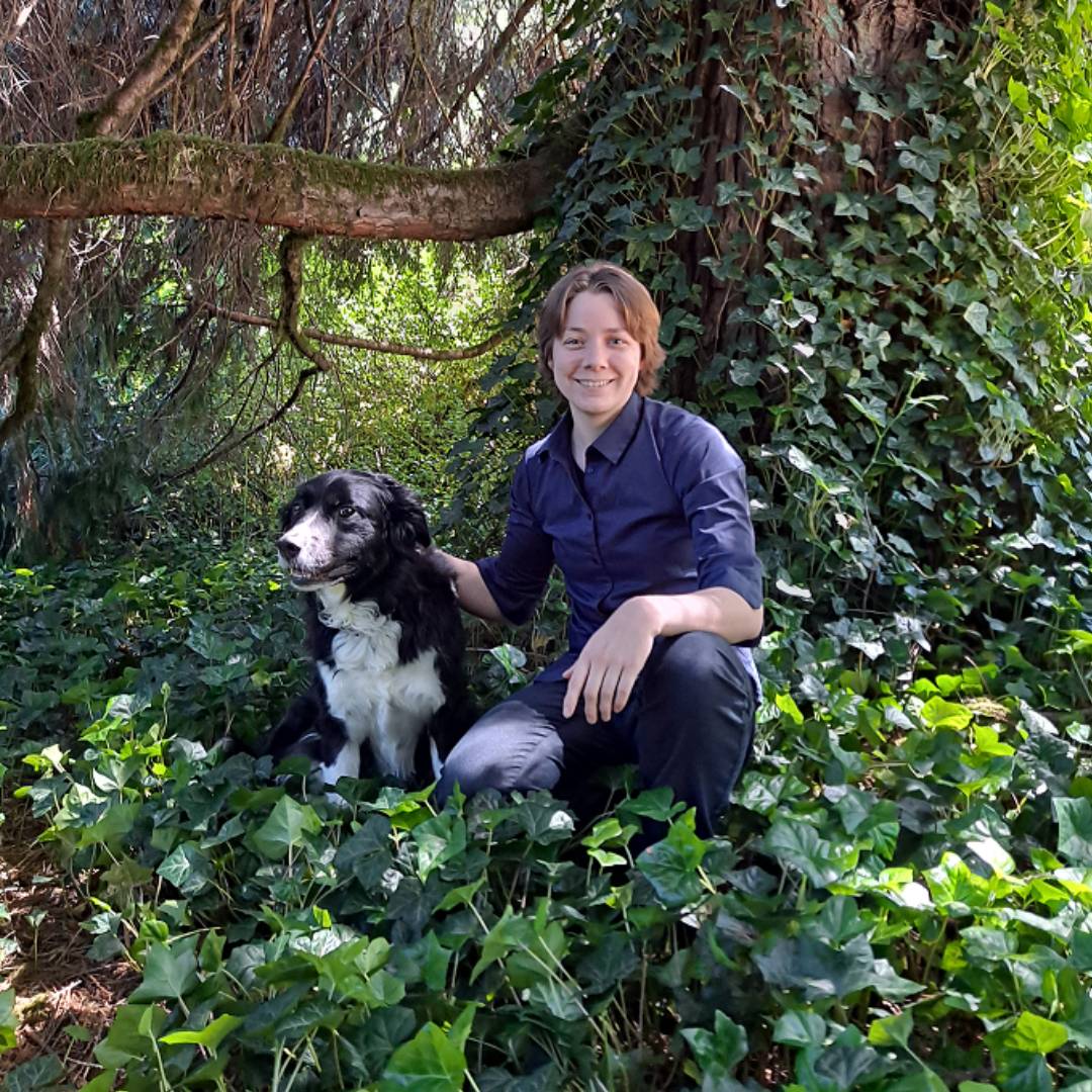 A family sitting with their dog
