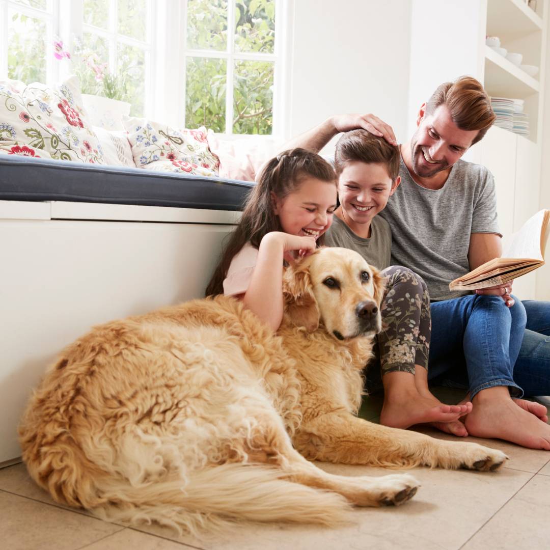 A family sitting with their dog